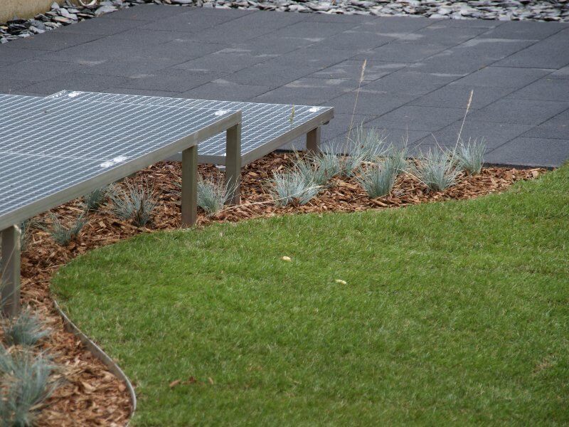 Tuin met terras, beplanting en zichtlijn naar de woning